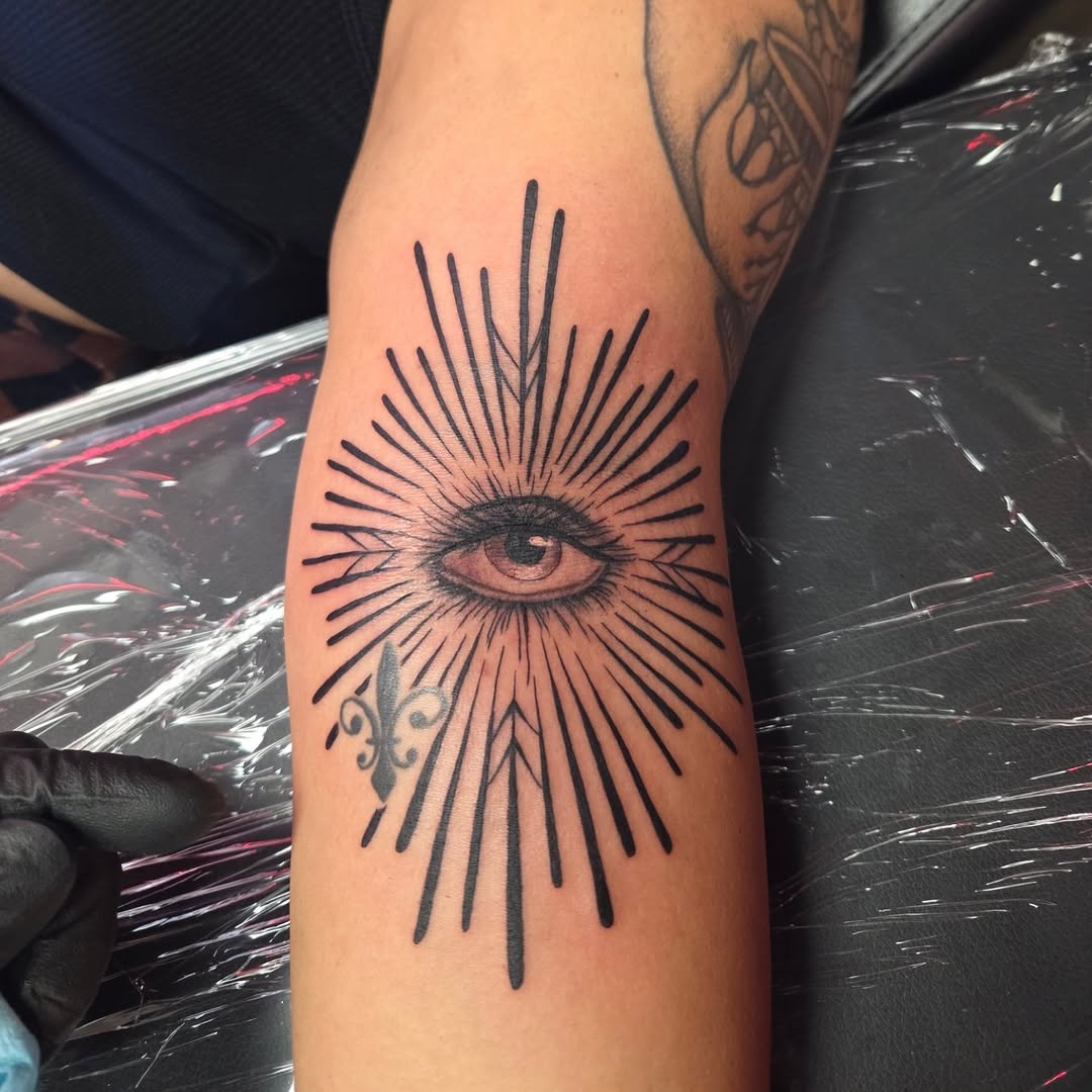 All-seeing eye with radiating linework tattoo