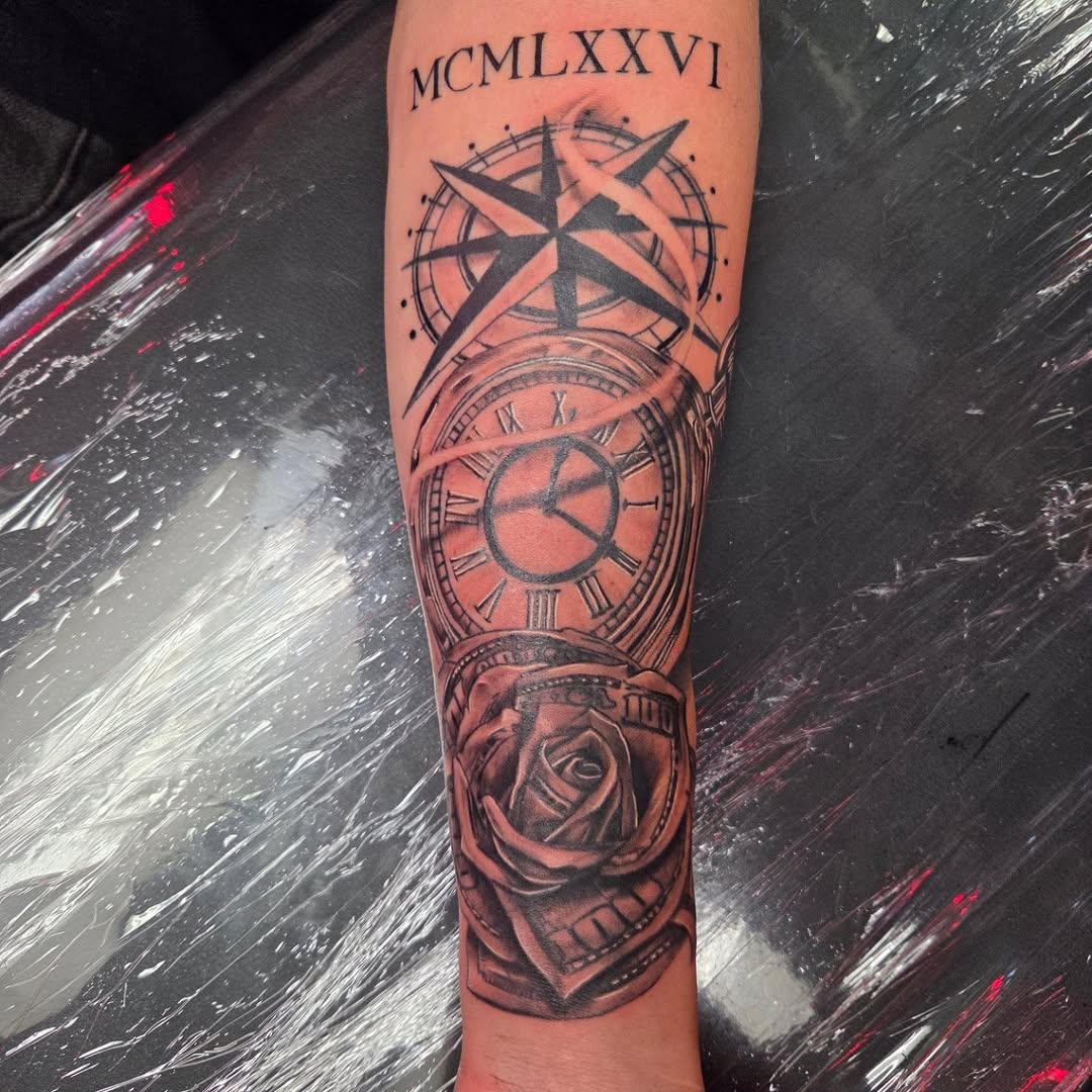 Black and grey compass, clock, and rose sleeve tattoo