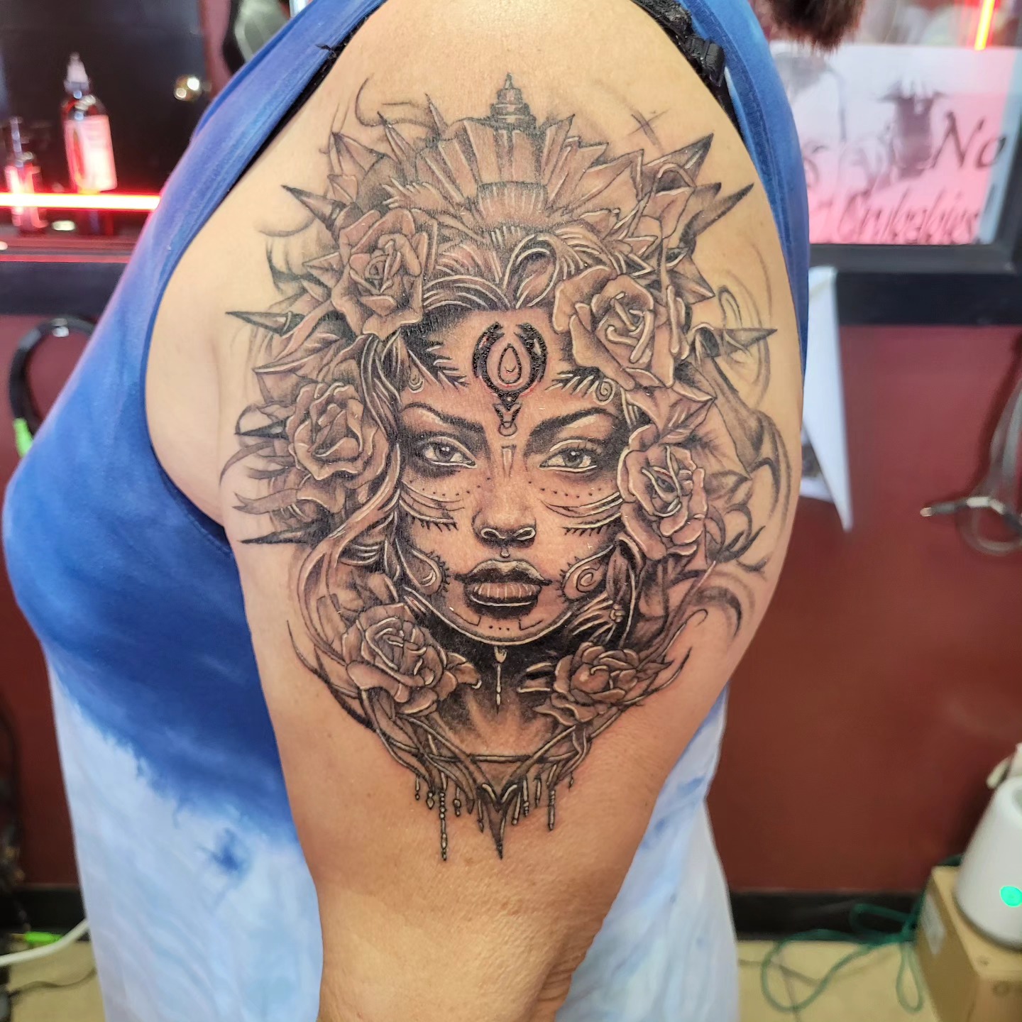 Black and grey ornamental woman with roses and headdress tattoo