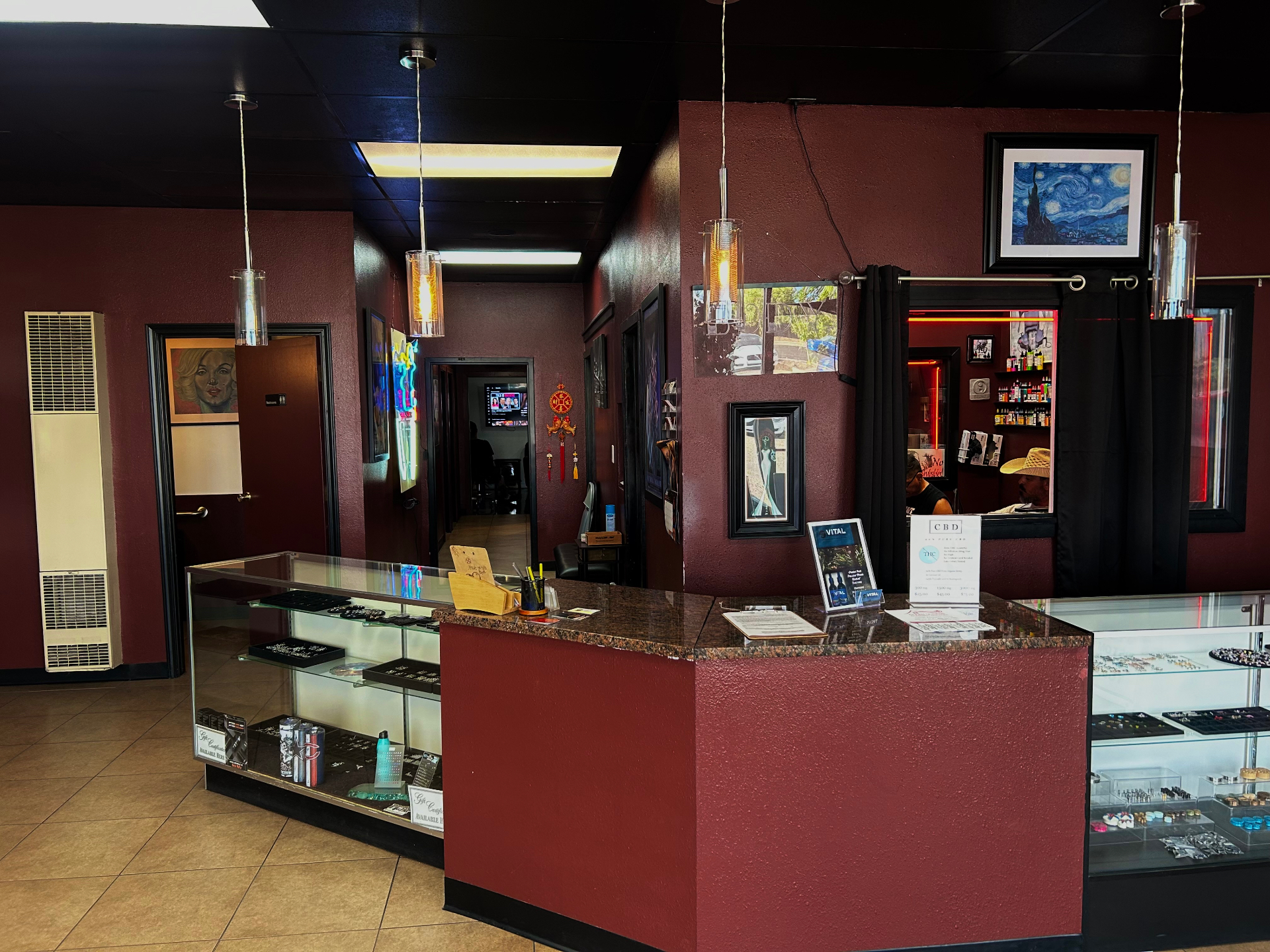 Valley Tattoo studio lobby with jewelry display cases and maroon walls