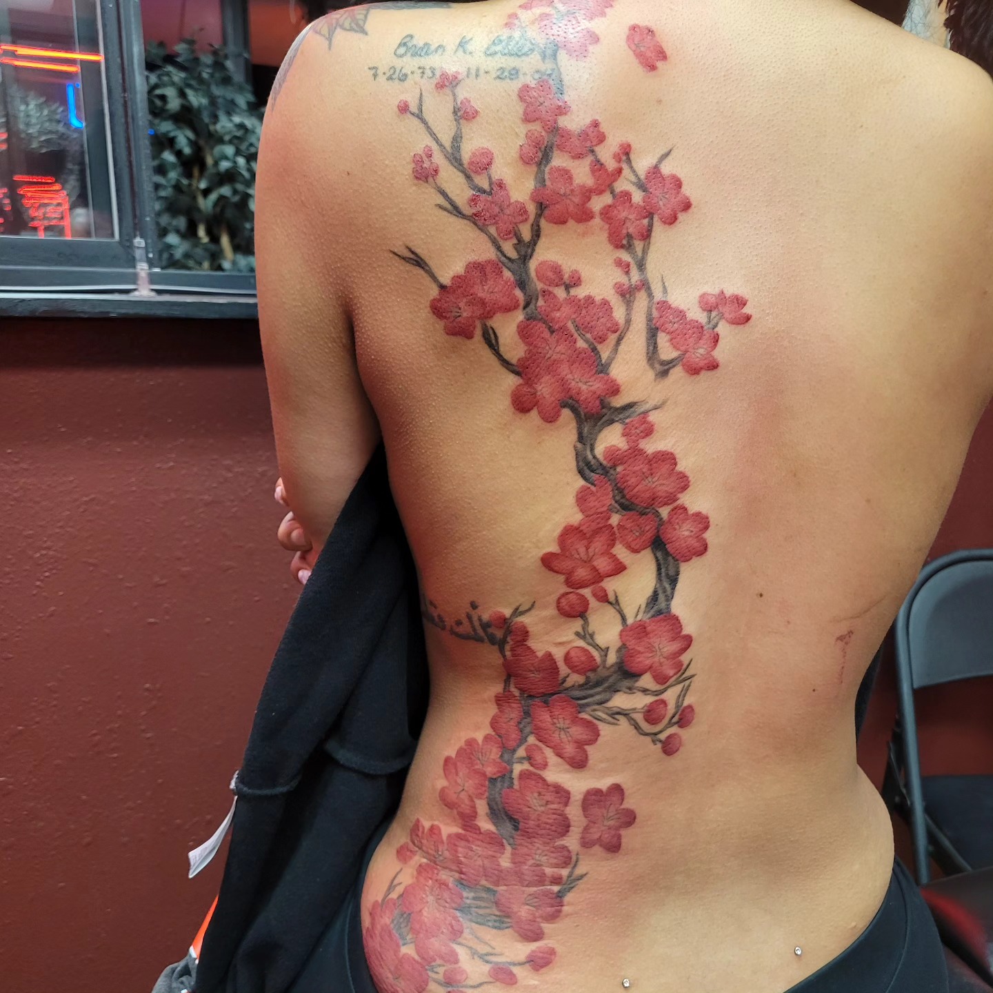 Red cherry blossom branch back tattoo