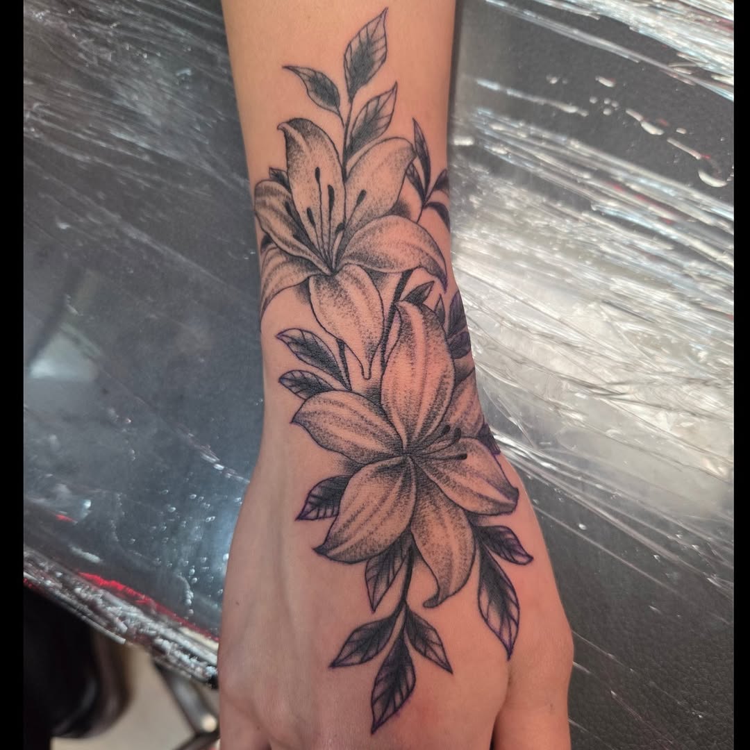 Dotwork lilies tattoo on hand and wrist